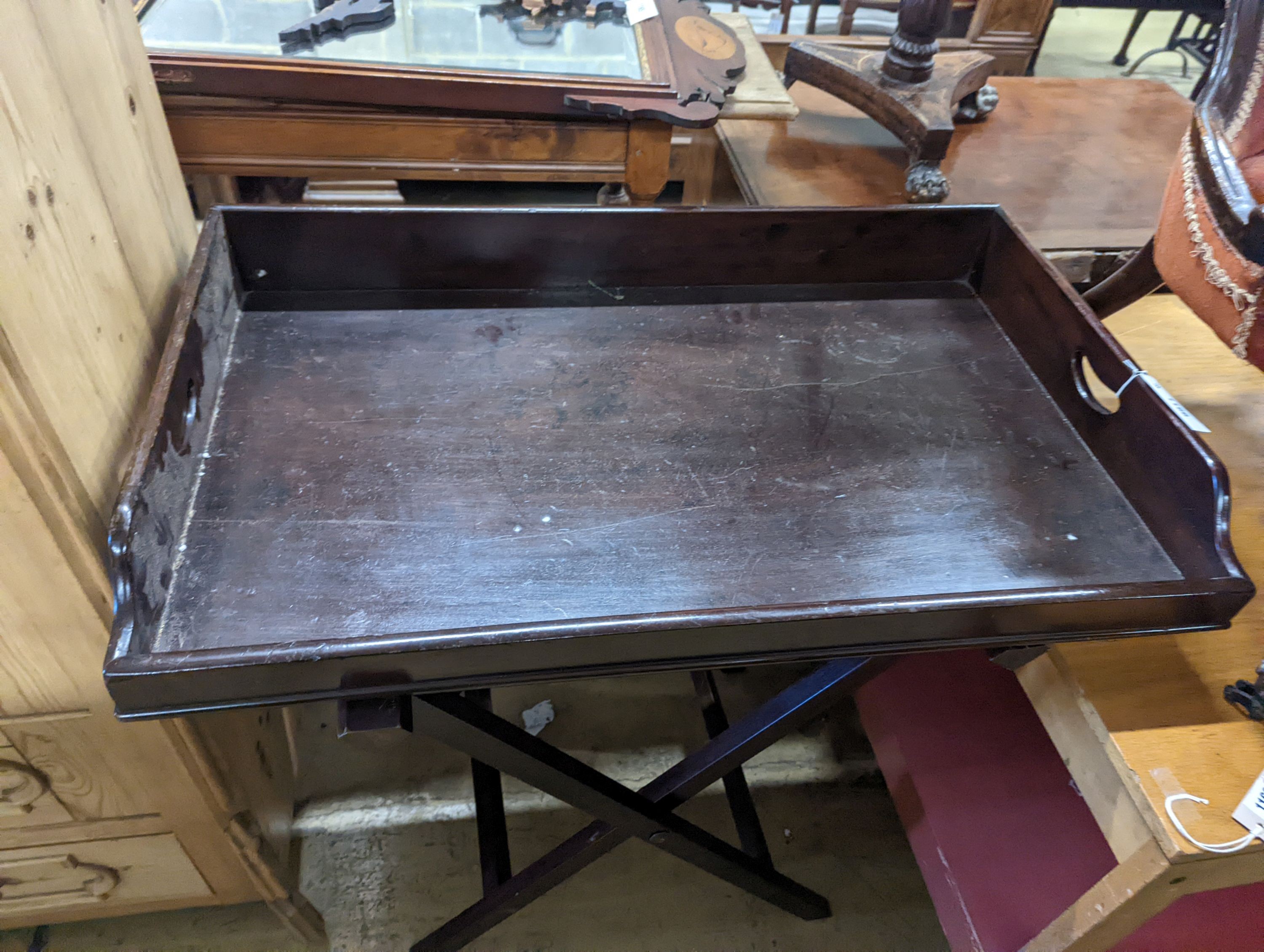 A large 19th century rectangular mahogany butler's tray on folding stand, width 89cm, depth 54cm